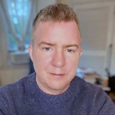 Chet Pancake has a sombre expression, blue eyes, light-skin, and short hair. The wear a pullover. The blurred background suggests they're in a home office.